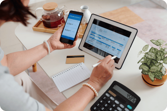 Entrepreneur using Meal Prep Tech software to manage orders, payments, and subscriptions on tablet and mobile.